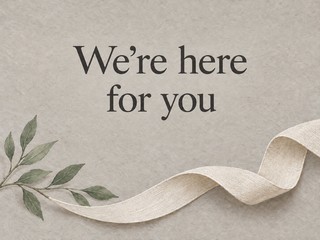 Illustration of an ivory linen ribbon and a branch on gray, with the message “We’re here for you”