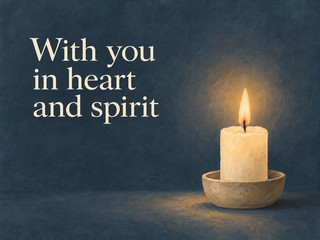 Illustration of a softly glowing candle on blue gray, with the message “With you in heart and spirit”